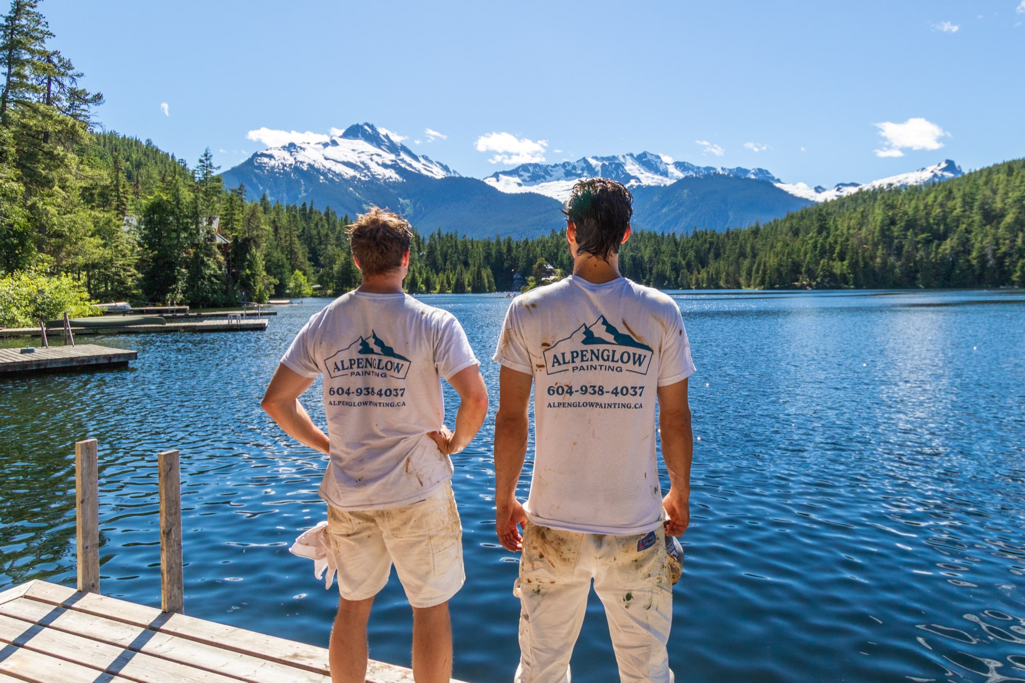 Two Alpenglow Painting crew members on a dock at Levette Lake, Whistler